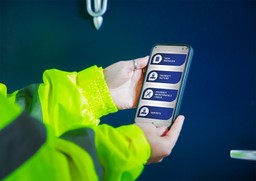 A technician inspects a Gerda Security fire doorset with the G-Smart app.