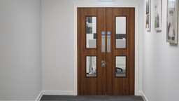 Modern office hallway with certified fire doors, enhancing fire safety for the workplace.